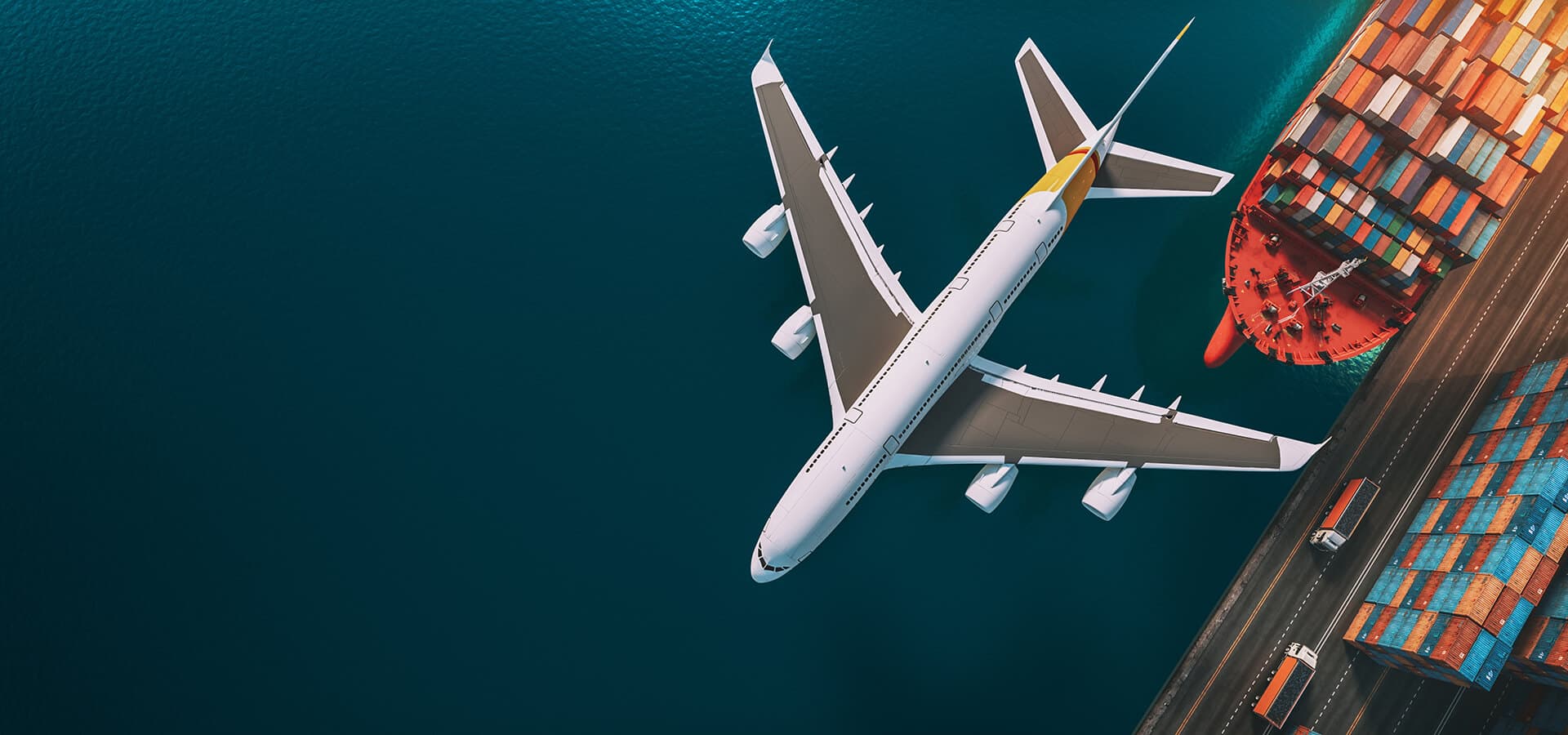 Aerial view of a cargo plane and container ship at a freight port